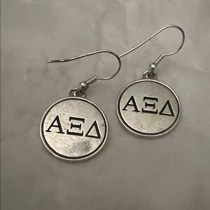 Silver Alpha Xi Delta sorority Greek letter dangle earrings.